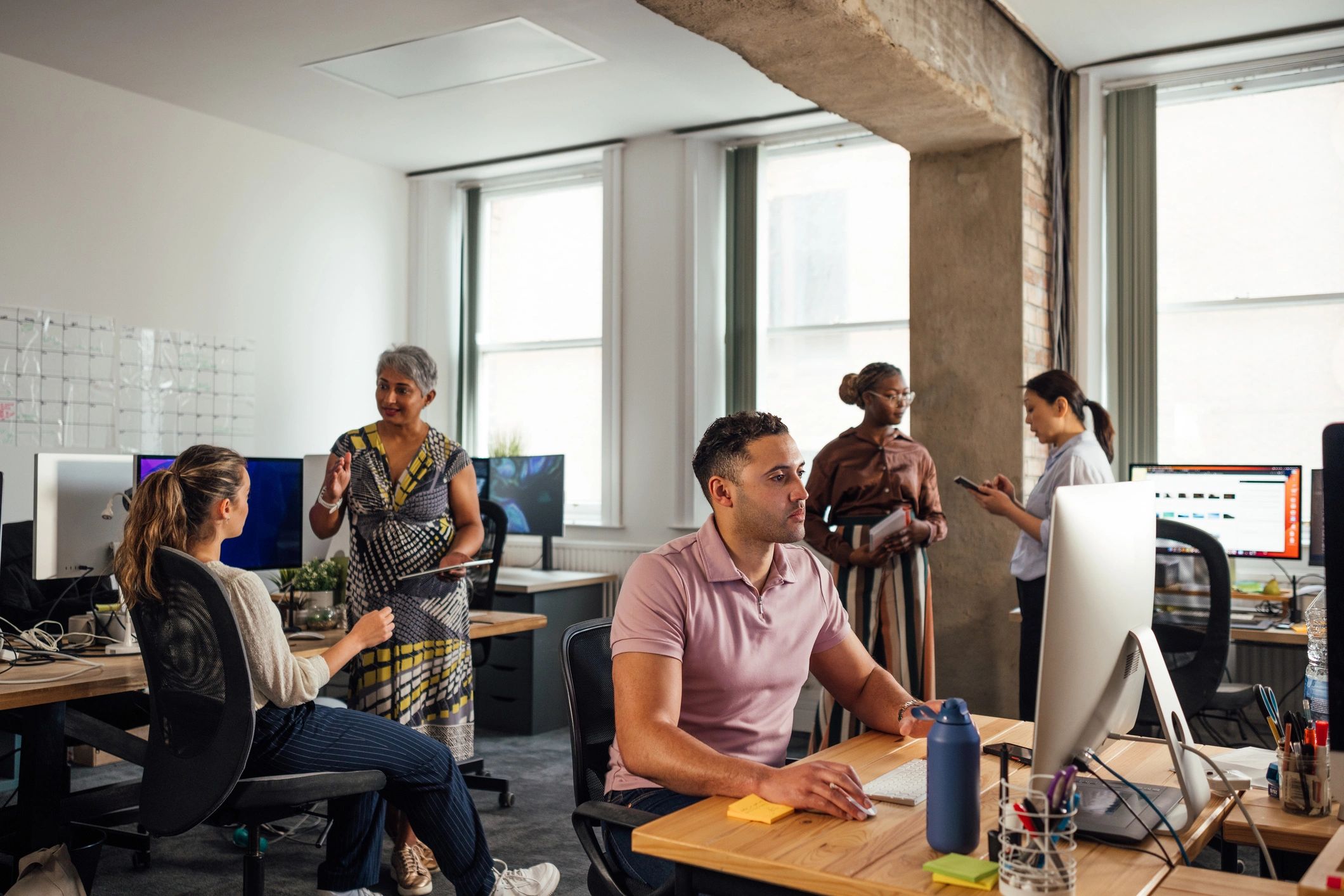 Managed IT support team working together in a modern office
