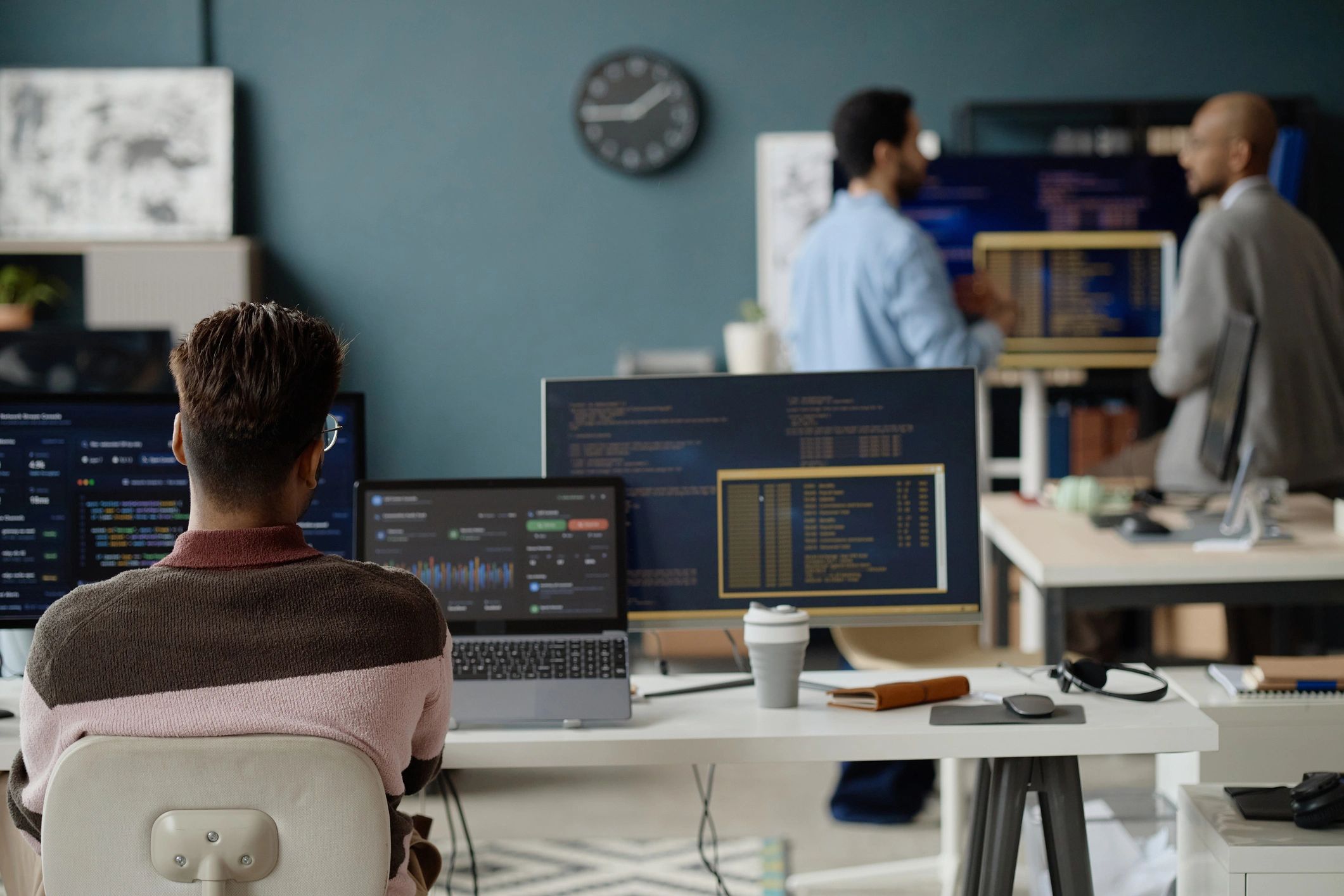 IT professional working at a coding workstation in a technology office